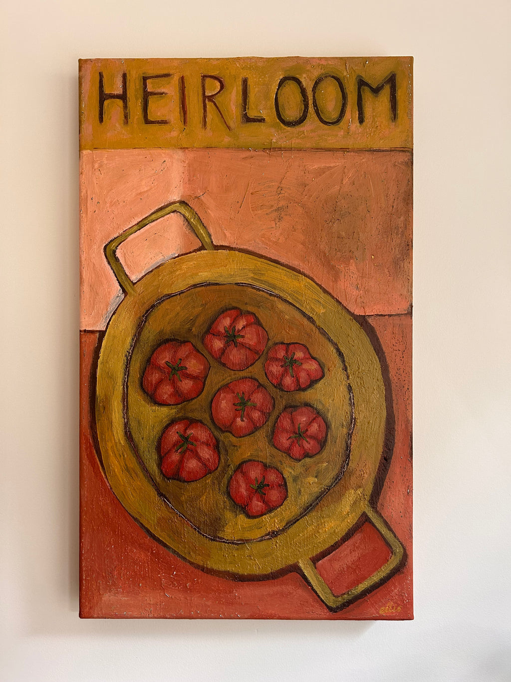 Artwork of pan of tomatoes and 'HEIRLOOM' text on a beige and red background.